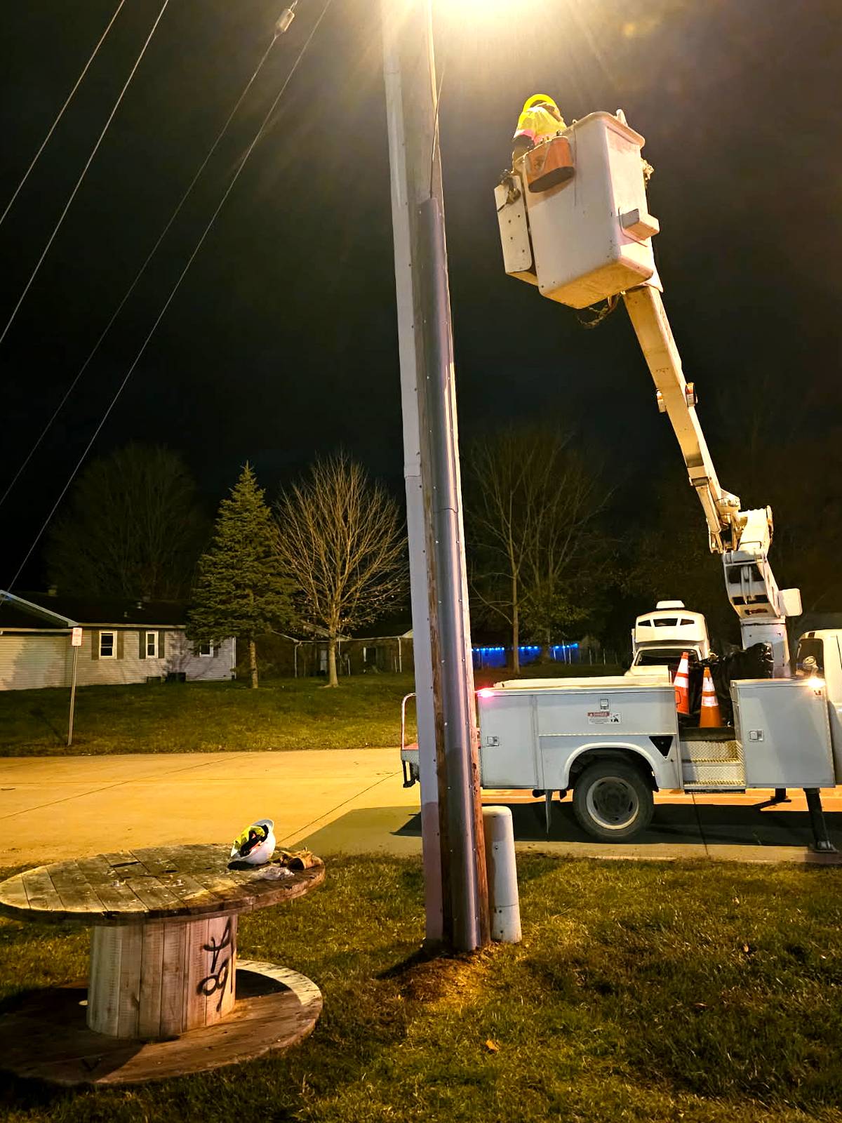 Night work with bucket truck at a street light